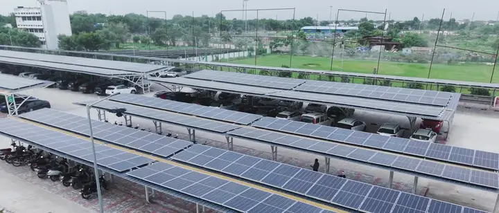Drone view of long rows of solar carports