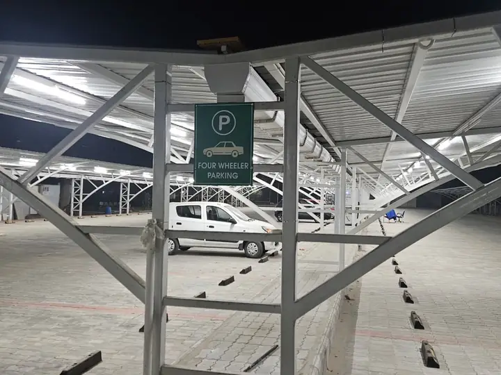 View under the steel carport canopy with a parked car