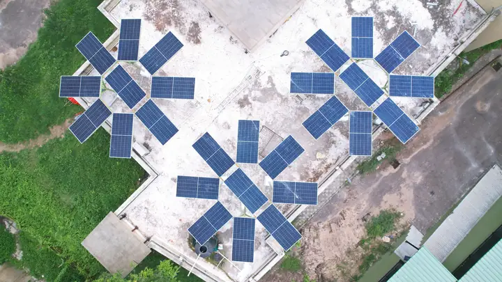 Three Solar Trees on a rooftop seen from a drone
